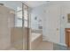 Bathroom featuring separate shower and soaking tub, with blue walls at 9836 Lake District Ln, Orlando, FL 32832