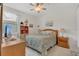 Cozy bedroom with a comfortable bed, a ceiling fan, bedside tables, and soft natural light at 9836 Lake District Ln, Orlando, FL 32832