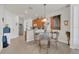 Bright dining area features a stylish chandelier, seating for four, and access to the kitchen at 9836 Lake District Ln, Orlando, FL 32832