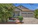 Charming home features a well-manicured lawn, neutral paint, shutters, and an attached two-car garage at 9836 Lake District Ln, Orlando, FL 32832