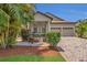Charming home featuring a manicured front yard, inviting entryway, and a two-car garage at 9836 Lake District Ln, Orlando, FL 32832