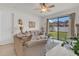 Bright living room featuring a neutral color palette, tile flooring, and a large window with backyard views at 9836 Lake District Ln, Orlando, FL 32832