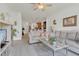 Open-concept living room with tile floors, neutral walls, and contemporary furniture at 9836 Lake District Ln, Orlando, FL 32832
