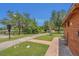 A restroom with a drinking fountain, next to a walking path and lush green grass with trees in a community park at 9836 Lake District Ln, Orlando, FL 32832