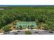 Overhead view of tennis courts in a community with trees and well-maintained landscaping at 9836 Lake District Ln, Orlando, FL 32832