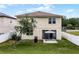 Home's backyard with patio, outdoor umbrella, and white fence that highlights the property's outdoor space at 1165 Stratton Ave, Groveland, FL 34736