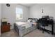 Cozy bedroom featuring a comfortable bed, a bright window, and a functional desk area for work or study at 1165 Stratton Ave, Groveland, FL 34736