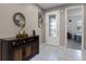Bright entryway with decorative mirror, storage, and tiled floor at 1165 Stratton Ave, Groveland, FL 34736