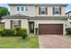 Charming two-story home with brown shutters and brick driveway at 1165 Stratton Ave, Groveland, FL 34736