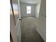 Cozy bedroom featuring neutral carpet, white walls, and a window allowing natural light at 1190 Seaside Mist Trl, Kissimmee, FL 34747