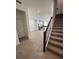 Open concept living space flowing into a modern kitchen with stainless steel appliances, light cabinets, and tile floors at 1190 Seaside Mist Trl, Kissimmee, FL 34747