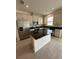Modern kitchen featuring stainless steel appliances, center island with dark granite countertops and tile flooring at 1190 Seaside Mist Trl, Kissimmee, FL 34747