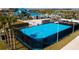 Community basketball court with blue surface, black fencing, and well-maintained landscaping at 1283 Blue Paradise Way, Clermont, FL 34714
