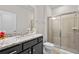 Bathroom featuring granite counters and shower with sliding glass doors at 1283 Blue Paradise Way, Clermont, FL 34714