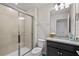 Bathroom features a glass shower, granite counters, and updated cabinets at 1283 Blue Paradise Way, Clermont, FL 34714