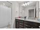 Bathroom featuring double sinks, granite counters and shower with curtain at 1283 Blue Paradise Way, Clermont, FL 34714