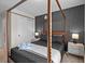 A primary bedroom features a four poster bed, with matching nightstands and decorative accents at 1283 Blue Paradise Way, Clermont, FL 34714