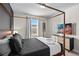 A primary bedroom features a four poster bed, dresser and a large window at 1283 Blue Paradise Way, Clermont, FL 34714
