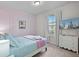 Comfortable bedroom with pastel pink wall, plush bedding, and television at 1283 Blue Paradise Way, Clermont, FL 34714