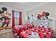 Fun bedroom with twin beds, Mickey Mouse accents, and cozy decor at 1283 Blue Paradise Way, Clermont, FL 34714