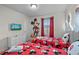 Charming bedroom features two twin beds with Mickey Mouse themed bedding and a flatscreen TV at 1283 Blue Paradise Way, Clermont, FL 34714