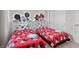 Charming bedroom features two twin beds with Mickey Mouse themed bedding and decor at 1283 Blue Paradise Way, Clermont, FL 34714