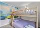 bunk room with Disney themed mural and a sturdy wooden bunkbed at 1283 Blue Paradise Way, Clermont, FL 34714