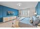 Comfortable bedroom featuring blue accent wall, white furniture, and light carpet at 1283 Blue Paradise Way, Clermont, FL 34714