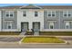 Charming townhome with light gray siding, white accents, and manicured landscaping at 1283 Blue Paradise Way, Clermont, FL 34714