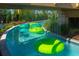 Relaxing lazy river with clear blue water, lush landscaping, and overhead rainfall features at 1283 Blue Paradise Way, Clermont, FL 34714