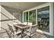 Cozy outdoor patio with dining set and sliding glass doors for indoor-outdoor living at 1283 Blue Paradise Way, Clermont, FL 34714