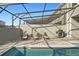 Inviting screened-in pool area with lounge chairs and a grill for outdoor entertaining at 1283 Blue Paradise Way, Clermont, FL 34714