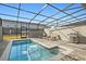Inviting pool area with lounge chairs and an outdoor grill for summer relaxation at 1283 Blue Paradise Way, Clermont, FL 34714