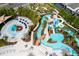 Aerial view of community water park with lazy river, splash pad, water slides and seating at 1283 Blue Paradise Way, Clermont, FL 34714