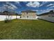 Spacious backyard with a large patio and green grass, perfect for outdoor enjoyment at 13046 Prairie Meadows Dr, Orlando, FL 32837