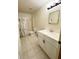 Tiled bathroom with a single sink vanity, toilet, and shower with curtain at 13046 Prairie Meadows Dr, Orlando, FL 32837