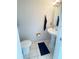 Compact half-bathroom with pedestal sink, tiled floor, and towel rack, offering convenience for guests at 13046 Prairie Meadows Dr, Orlando, FL 32837