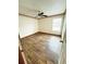 Bedroom with wood-look flooring, a ceiling fan, and a window at 13046 Prairie Meadows Dr, Orlando, FL 32837