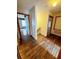 Hallway with hardwood floors and natural wood trim around doorways at 13046 Prairie Meadows Dr, Orlando, FL 32837