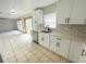 Open kitchen area showcasing white cabinetry, stainless appliances, and a view into the adjoining living space at 13046 Prairie Meadows Dr, Orlando, FL 32837