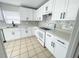 Beautiful kitchen with white cabinets, modern appliances, and tile flooring, creating an inviting cooking environment at 13046 Prairie Meadows Dr, Orlando, FL 32837
