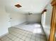 Large living room with neutral tile flooring, ceiling fan, and bright windows at 13046 Prairie Meadows Dr, Orlando, FL 32837