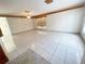 Spacious living room featuring tile flooring, wood trim accents, and ample natural light from the window at 13046 Prairie Meadows Dr, Orlando, FL 32837