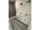 Bathroom featuring double vanity, modern lighting fixtures, and a gray-tiled shower stall at 13265 Sw 85Th Cir, Ocala, FL 34473