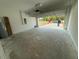 Spacious garage with open door, water heater on left and view of the brick driveway at 13265 Sw 85Th Cir, Ocala, FL 34473