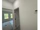 Hallway view leading to a bedroom, showcasing neutral paint and modern door frames at 13265 Sw 85Th Cir, Ocala, FL 34473
