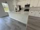 A well-equipped kitchen featuring white cabinets, a spacious island, and quartz countertops at 13265 Sw 85Th Cir, Ocala, FL 34473