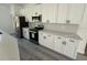 A well-equipped kitchen featuring white cabinets, modern stainless steel appliances, and quartz countertops at 13265 Sw 85Th Cir, Ocala, FL 34473
