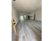 A spacious living room with wood-look vinyl floors offering an open concept layout at 13265 Sw 85Th Cir, Ocala, FL 34473