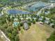 Aerial view of a community featuring lakes, a pool, clubhouse, and beautiful landscaping at 1396 Riley Cir, Deland, FL 32724